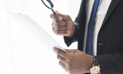 businessman-with-papers-loupe_23-2147768584