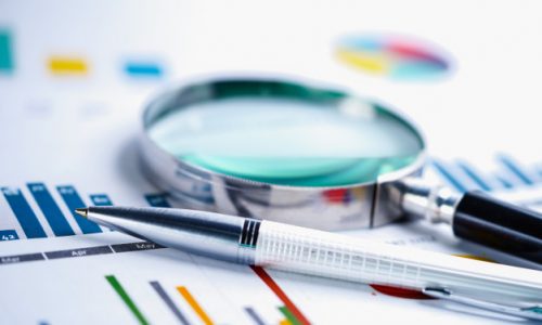 magnifying-glass-charts-graphs-spreadsheet-paper_39768-291